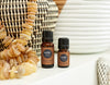 All Spice essential oils next to woven basket and beads