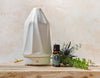 Essential oil with greenery next a diffuser