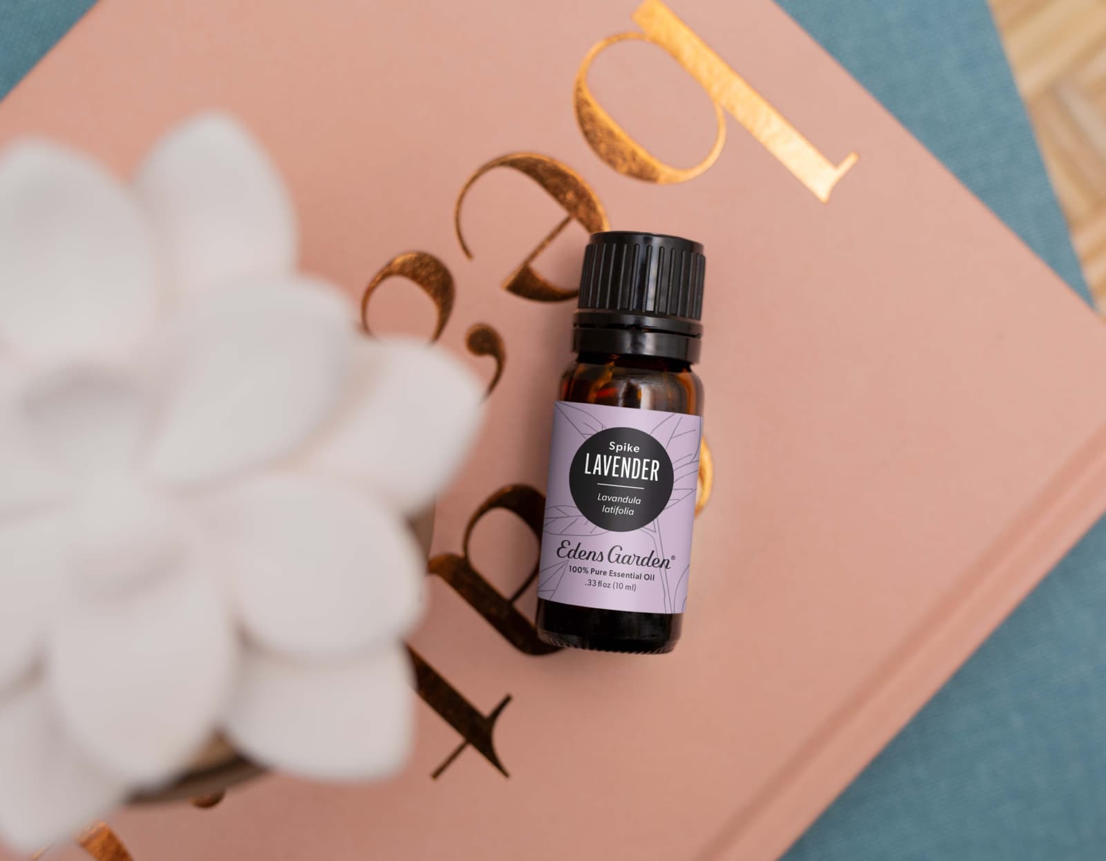 Lavender essential oil laying on top of a book