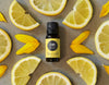 Lemon essential oil surrounded by lemon slices