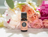 Saro essential oil surrounded by a bouquet of flowers