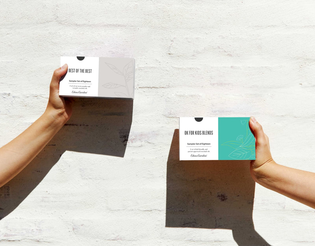 Hands holding out essential oil sampler set boxes