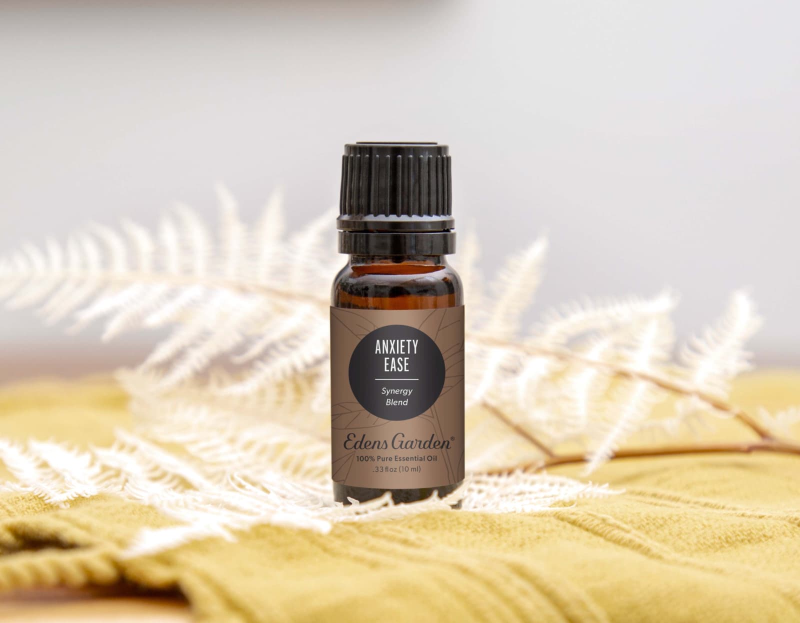Amber glass bottle of 'Anxiety Ease' essential oil blend on a soft natural background, suggesting calming aromatherapy use