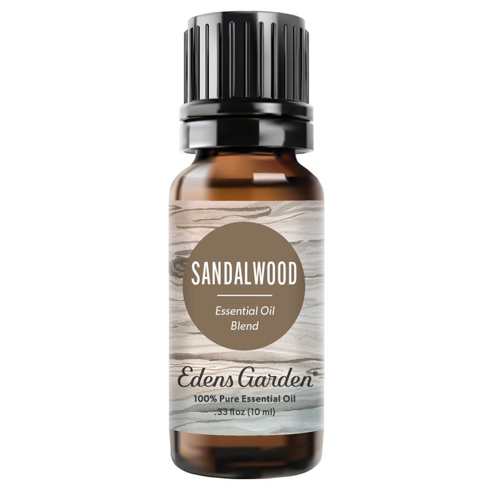 A 10 ml amber glass bottle of Edens Garden Sandalwood Essential Oil Blend with a black ribbed cap and a rustic wood-grain label.