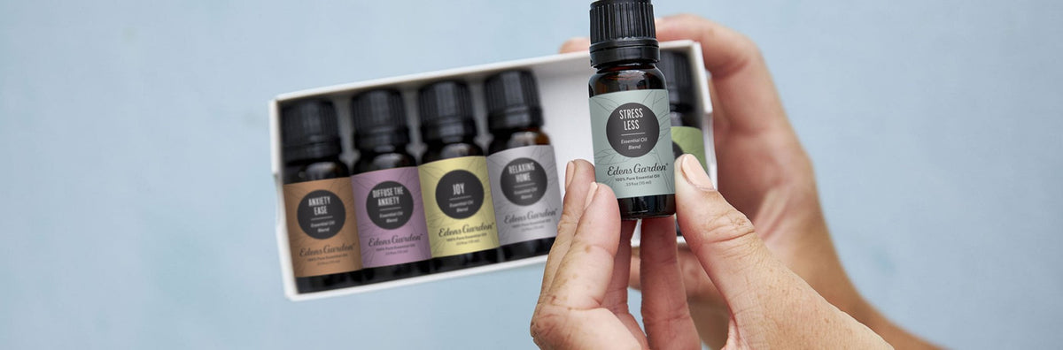 A person taking an essential oil out of a set of oils