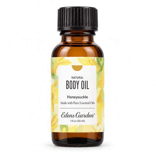 Edens Garden Honeysuckle body oil in a 1 fl oz amber glass bottle with a black ribbed cap and a yellow floral label, on a white background.