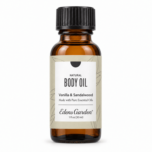 A 1 fl oz amber glass bottle of Edens Garden Vanilla & Sandalwood body oil with a black ribbed cap and a beige label, shown on a white background.