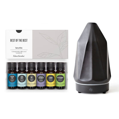Set of six essential oil bottles and a diffuser on a white background