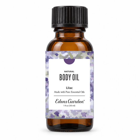 Edens Garden Lilac Natural Body Oil in a 1 fl oz amber glass bottle with a black ribbed cap and a white label decorated with purple lilac flowers.