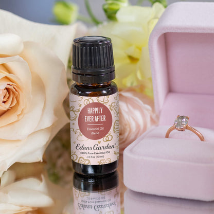 Edens Garden Happily Ever After essential oil bottle with a ring in a pink box and flowers in the background