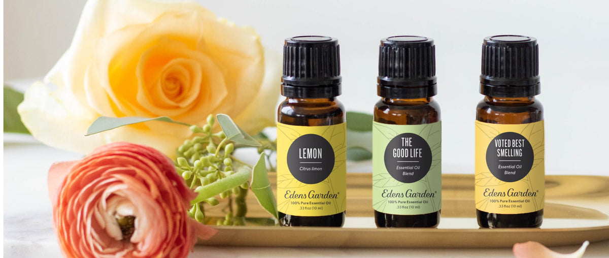Three essential oils on a tray surrounded by flowers