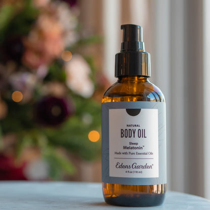 Bottle of Melatonin Sleep Edens Garden body oil with a blurred background
