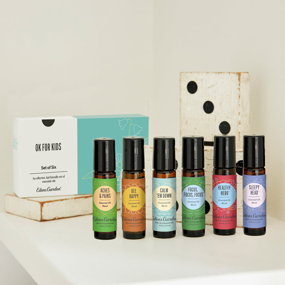 Set of six small bottles with colorful labels on a white surface