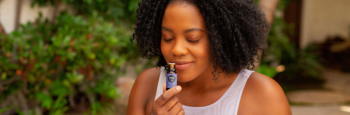 A woman inhaling an essential oil