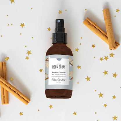Room spray bottle with cinnamon sticks on a decorative background