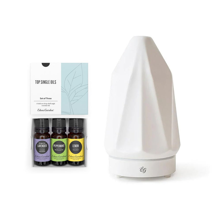 White diffuser with essential oil bottles on a white background