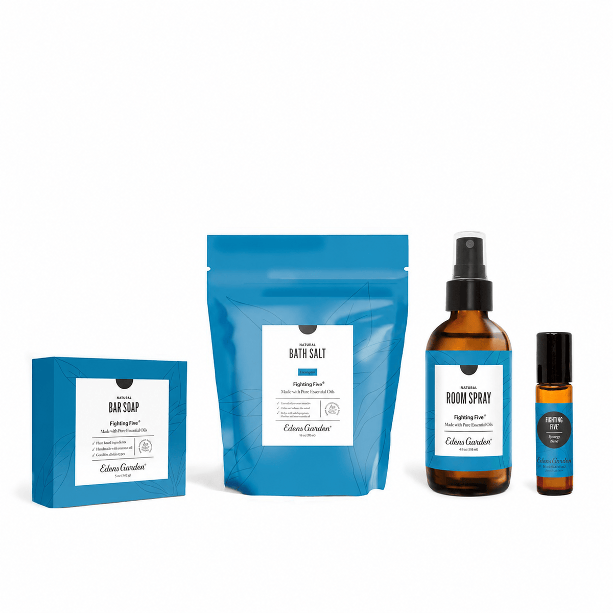 A coordinated bath and body gift set on a white background, including a blue boxed bar soap, a large blue stand-up pouch labeled bath salt, an amber bottle of room spray, and a small amber roller bottle with a blue label.