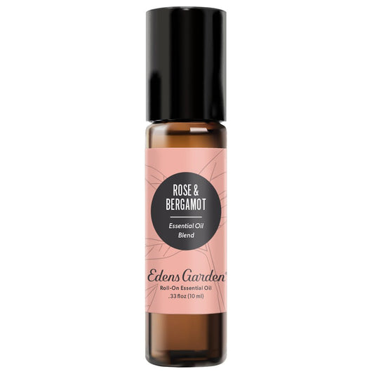 A clear glass roll-on bottle with a black cap and a label reading 'Rose & Bergamot Essential Oil Blend' by Edens Garden.